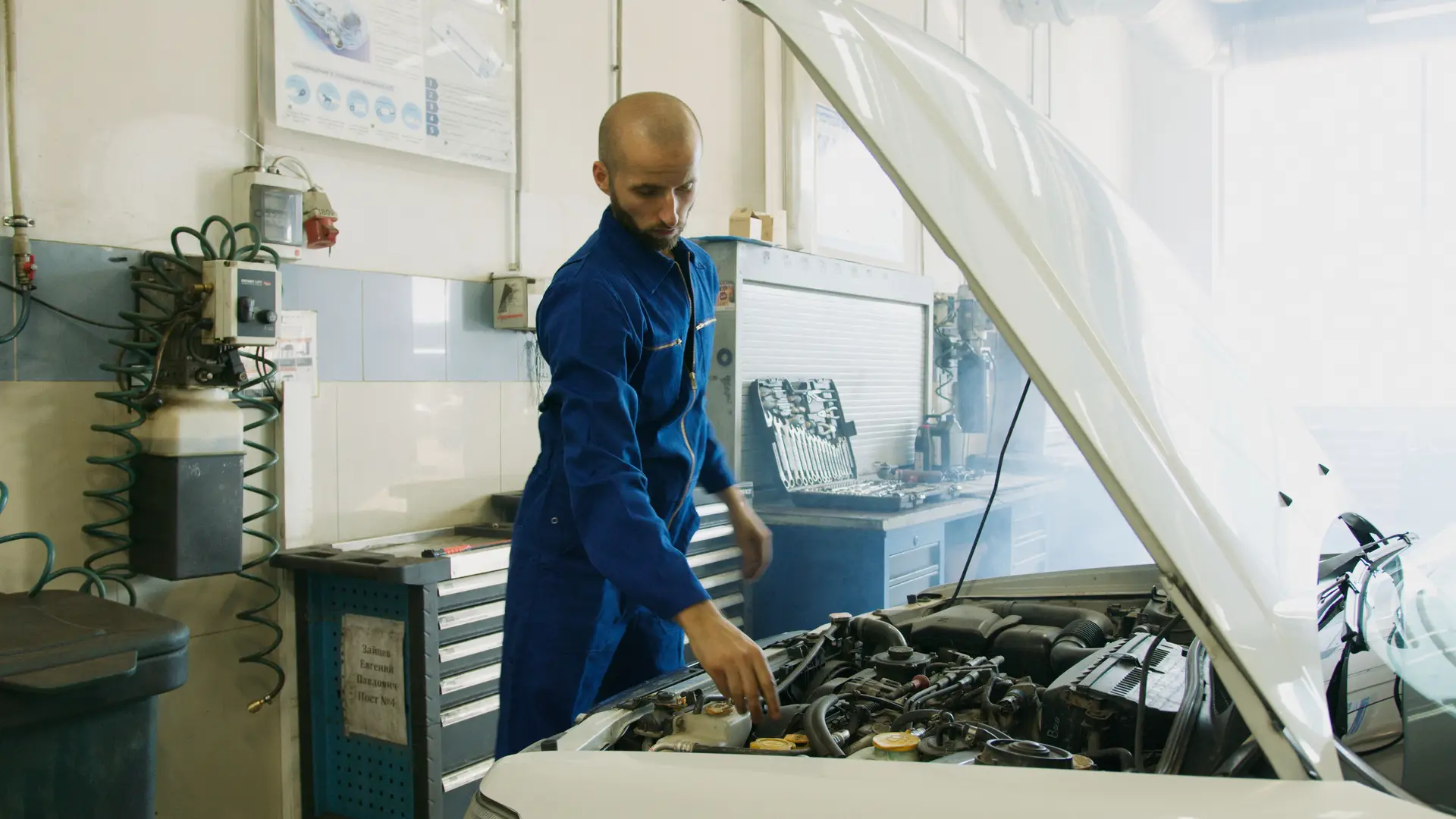 Mechanic inspecting vehicle engine bay
