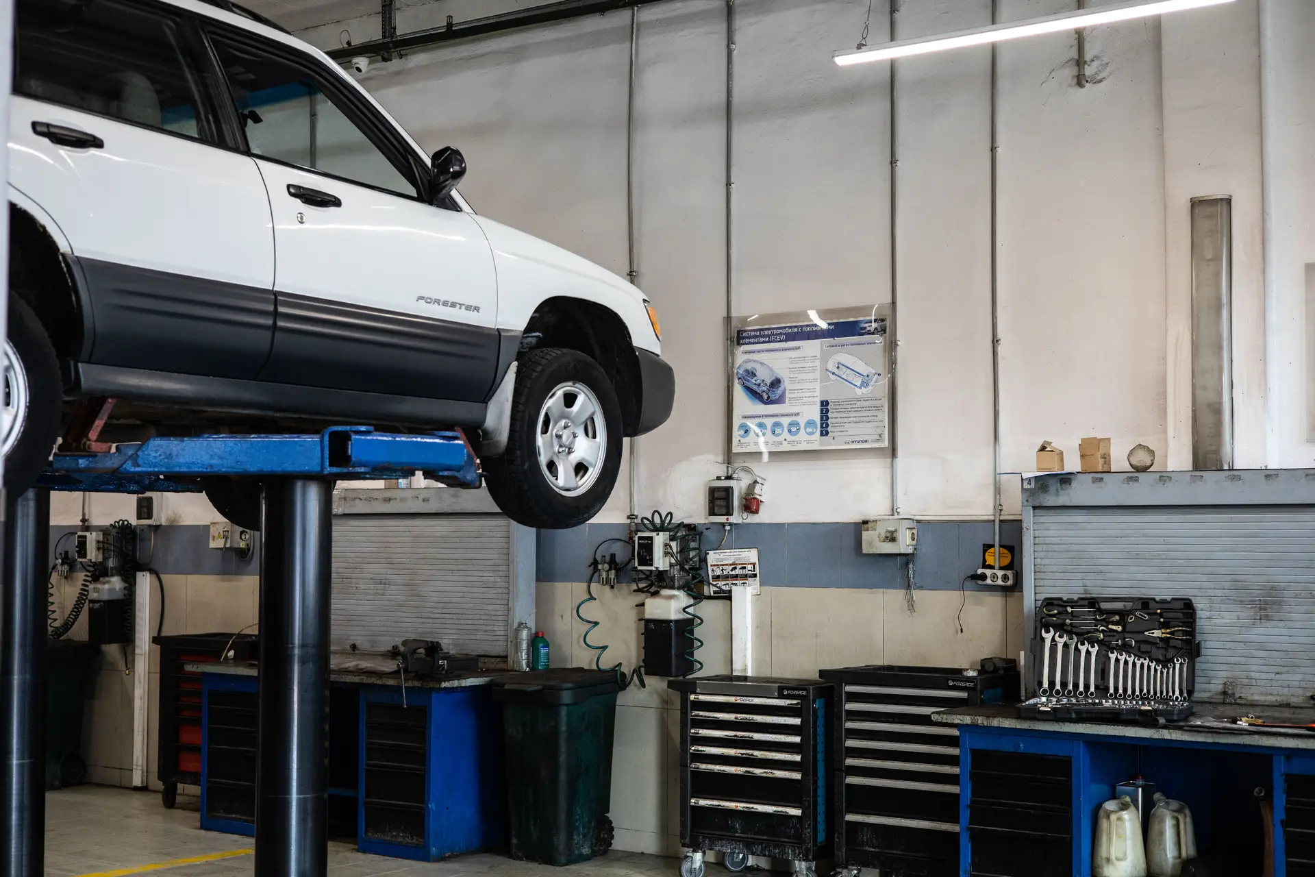 Professional Australian automotive workshop with car on lift